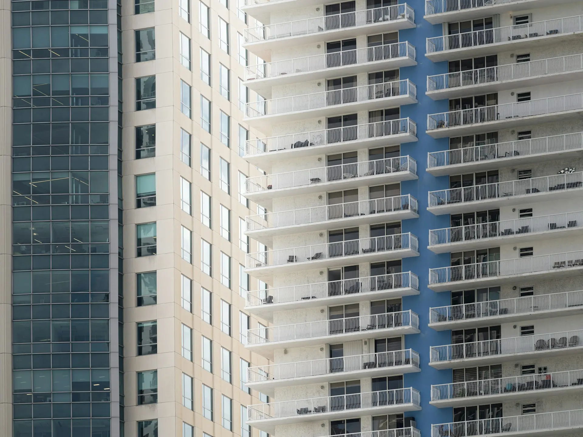 Residential tower with rows of white balconies