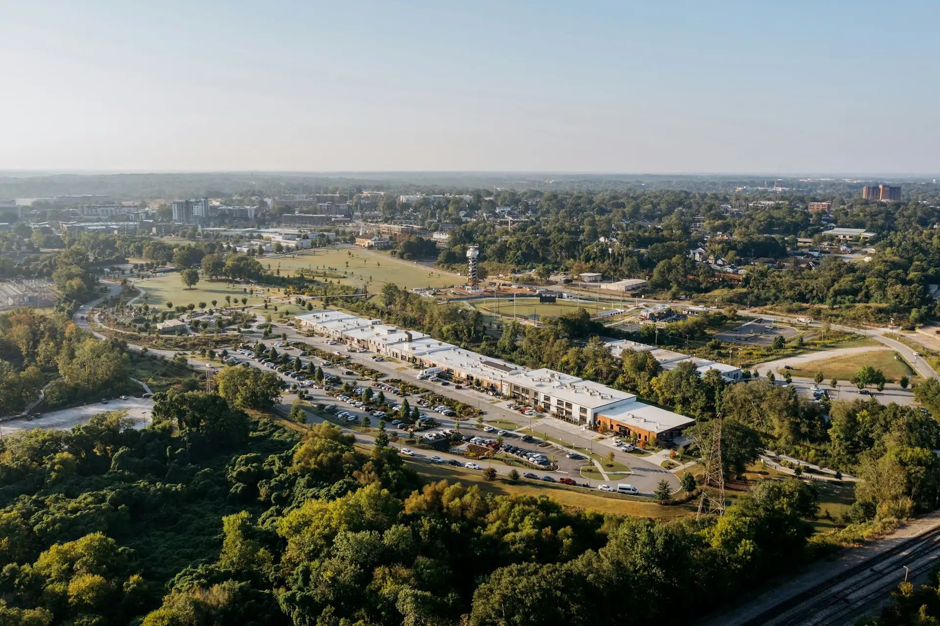 Aerial view of a low-rise commercial complex and parking