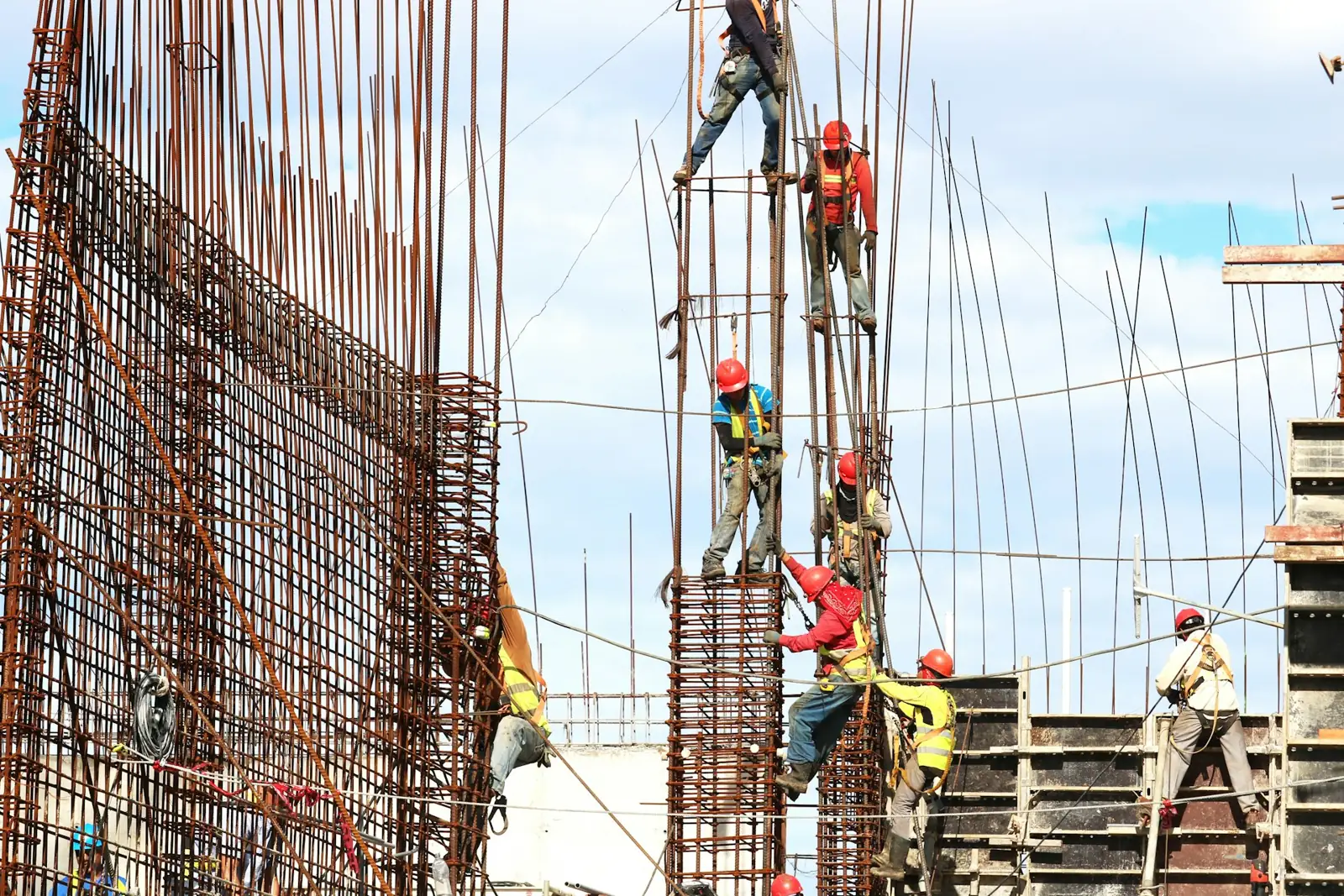 Crew tying rebar columns on an active construction site (representative image)