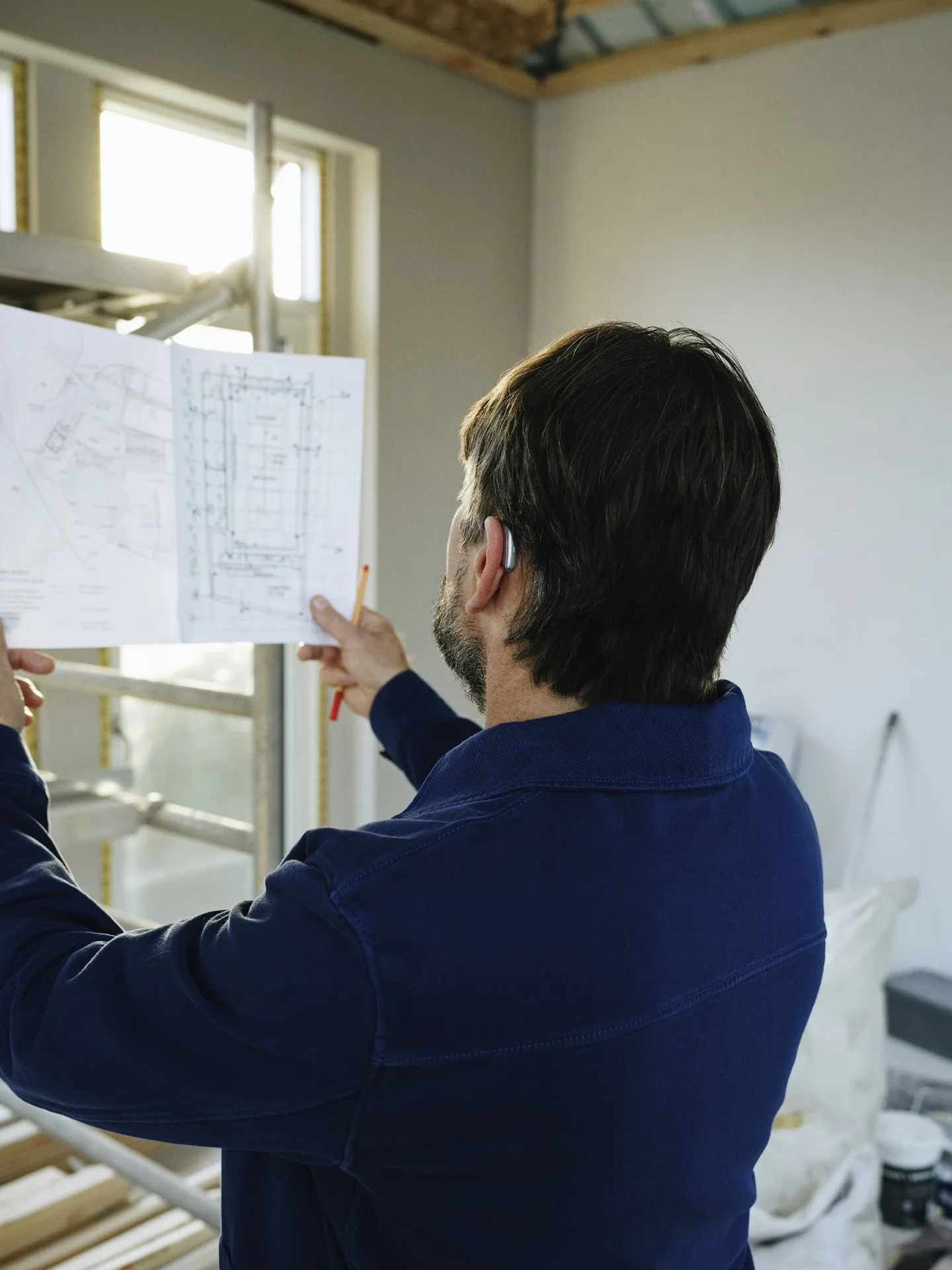 Reviewing site plans inside a building under construction
